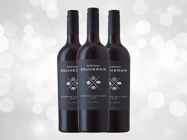 Three Black Chateau Souverain bottles against silver background