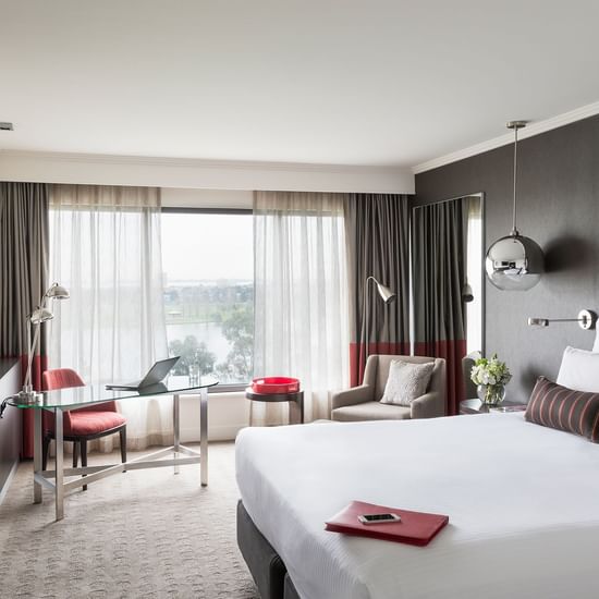 King bed and seating area in Classic Room at Pullman Albert Park