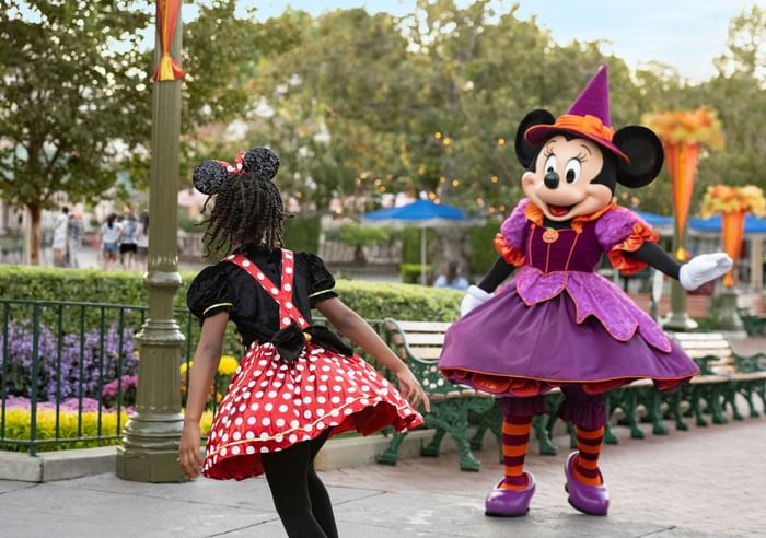 Mini mouse mascot playing with a girl in Disneyland Resort near Anaheim Portofino Inn & Suites