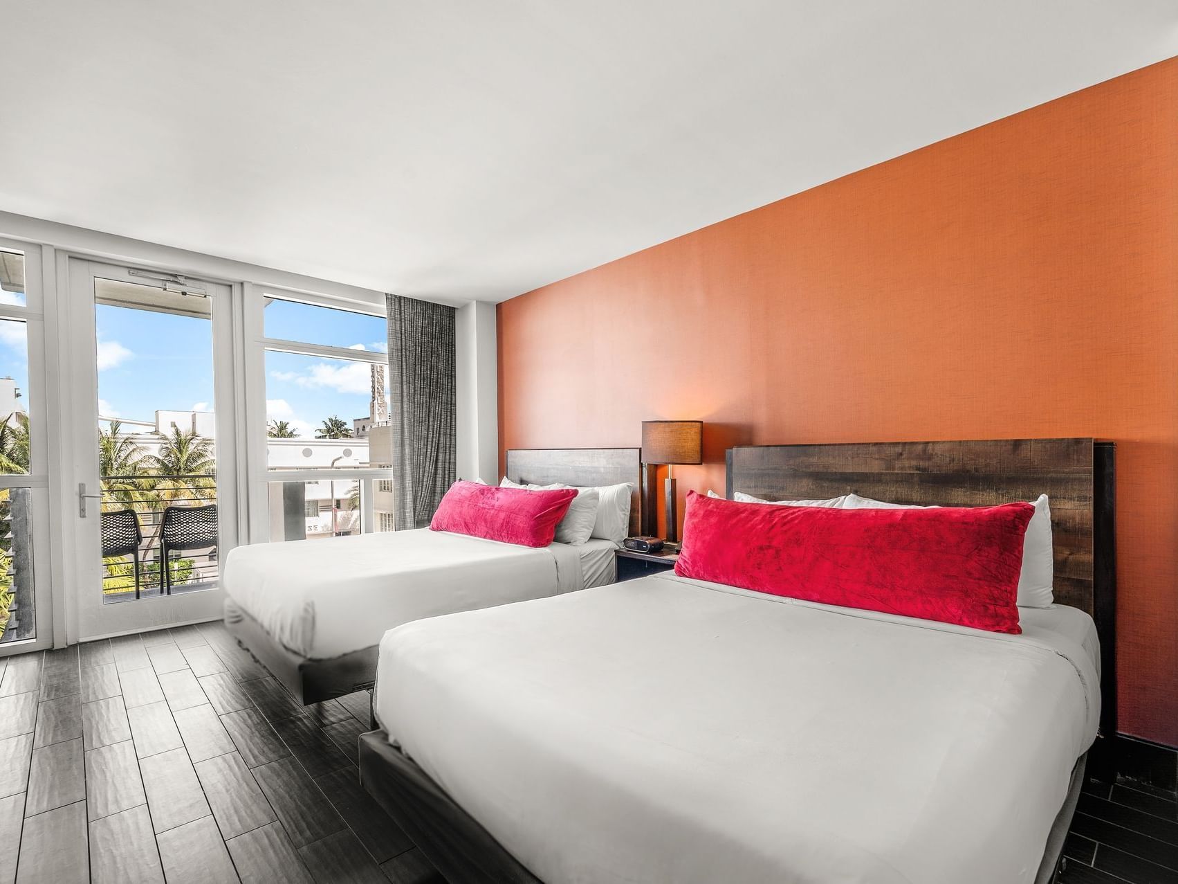 Cozy double beds by the balcony window in Deluxe Double With Balcony at Fairwind Hotel Miami