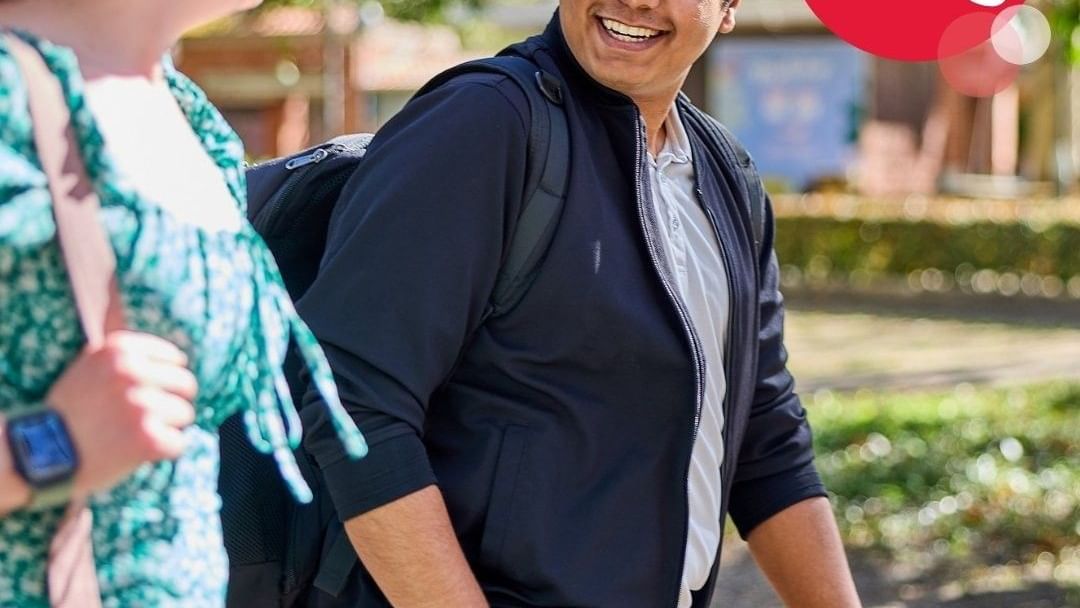 Smiling man with backpack talking to woman, Apply Now for 2026, Life's Easier on Campus.