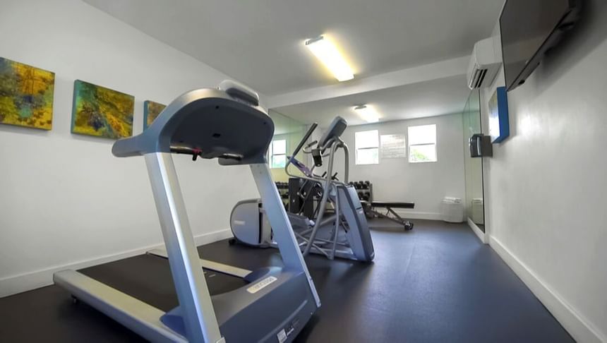 Gym that includes an Elliptical machine, a treadmill, a bike and