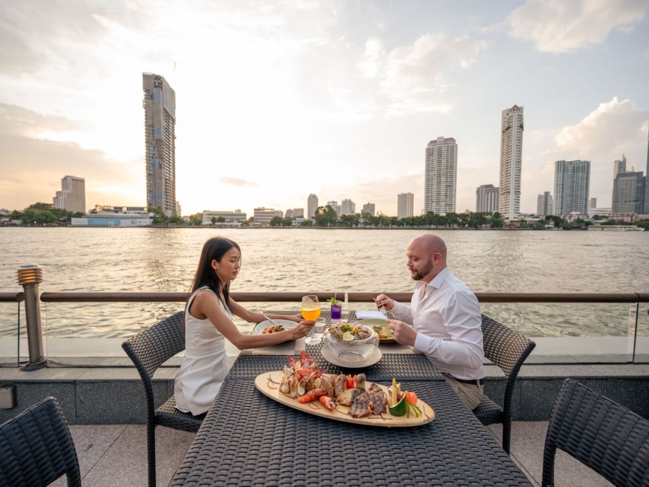 A couple enjoying a meal at Chatrium Hotels & Residences