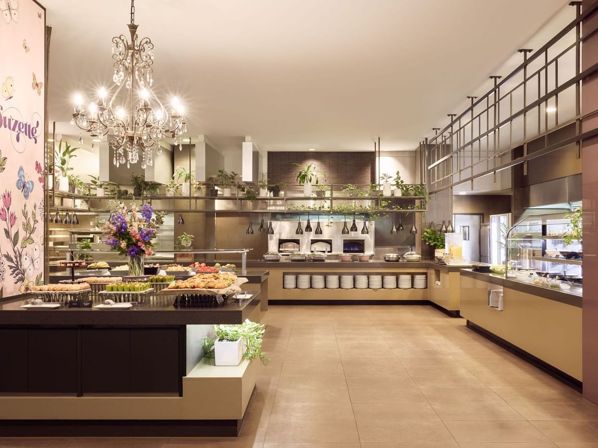 Buffet area in Restaurant Bistro Suzette with chandelier, food displays, and floral decoration at Sofitel Brisbane Central