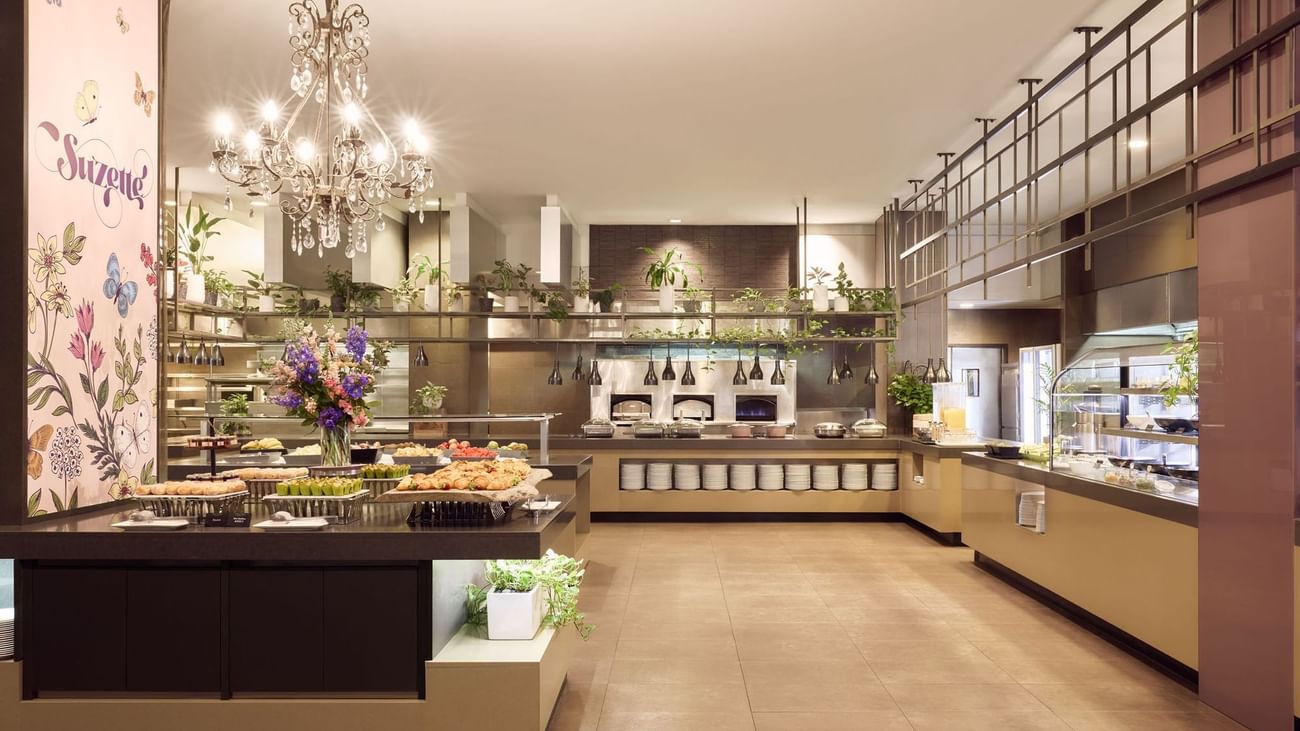 Elegant buffet area with chandeliers and food displays in Suzette at Sofitel Brisbane Central