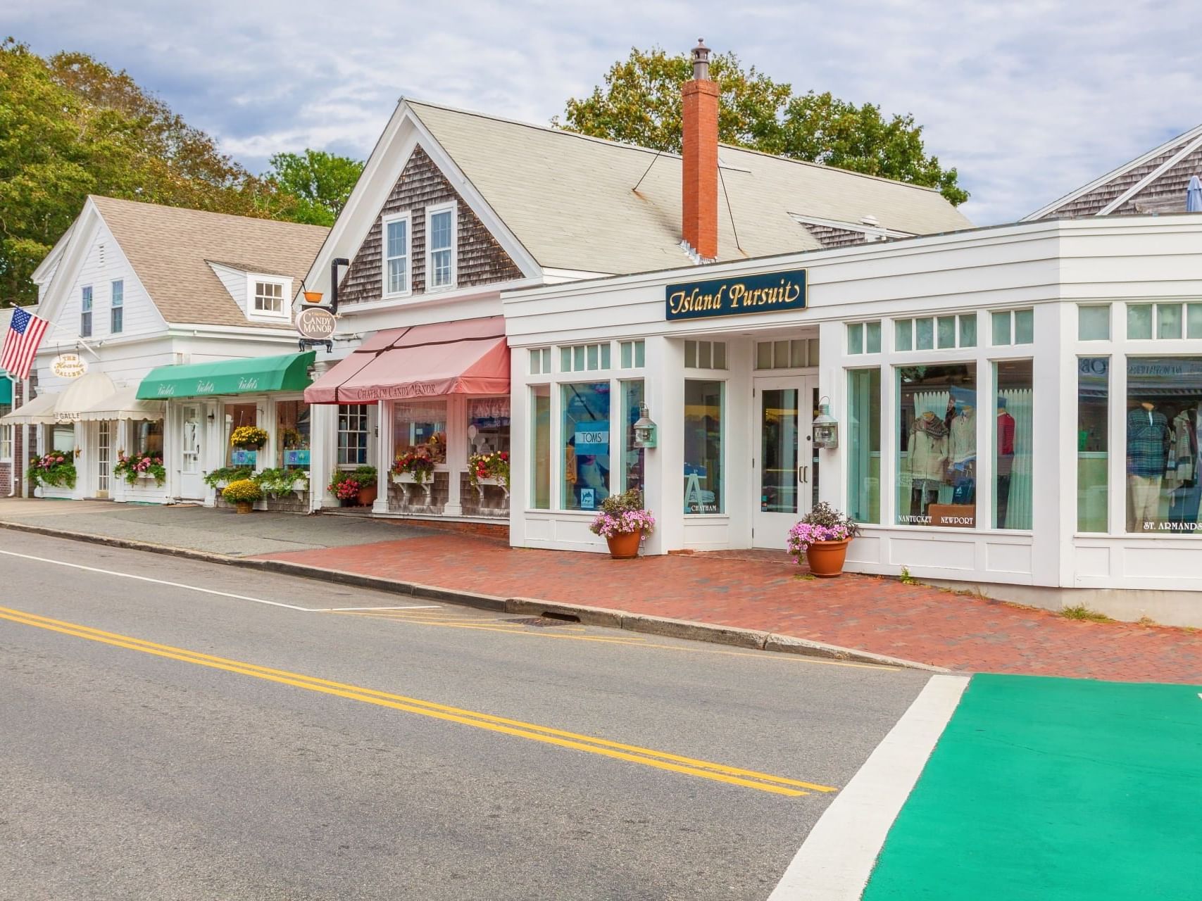 Small town street lined with stores and flower decors near Chatham Tides Resort
