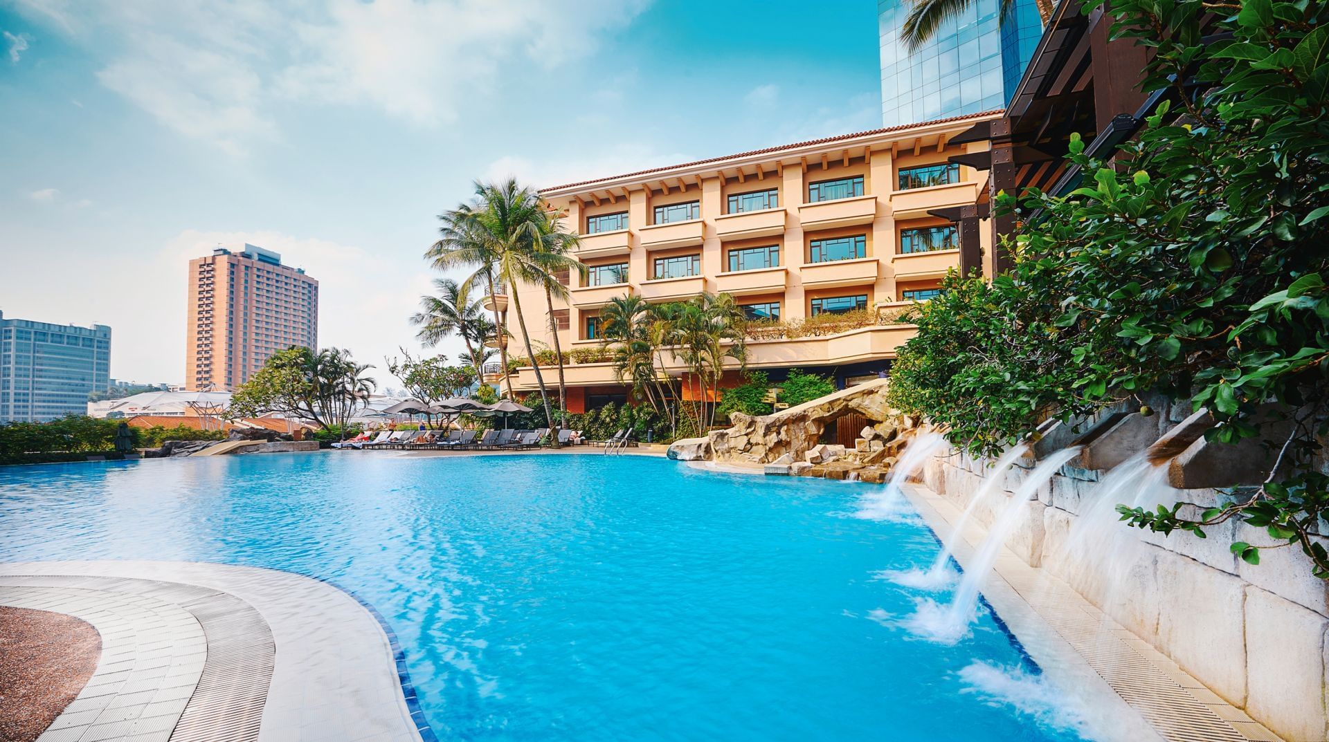 Outdoor pool area with trees at Paradox Hotels