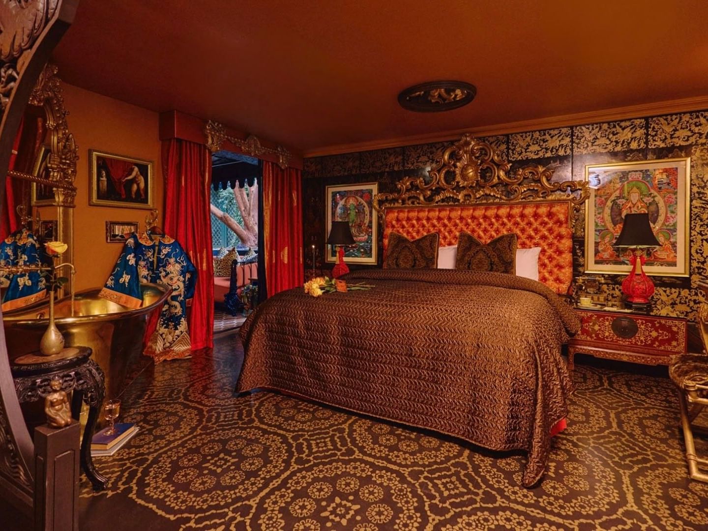 Grand Belle Terrace features gold & red bedroom an ornate headboard and gold sink at Petit Ermitage