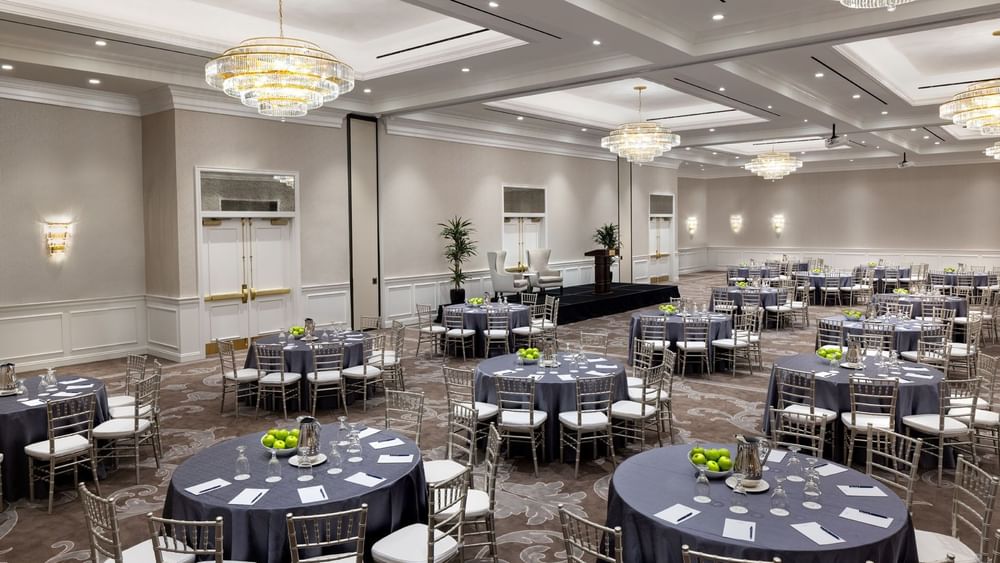 Turtle Creek Ballroom with round tables and chairs set for an event at Warwick Melrose in Dallas.