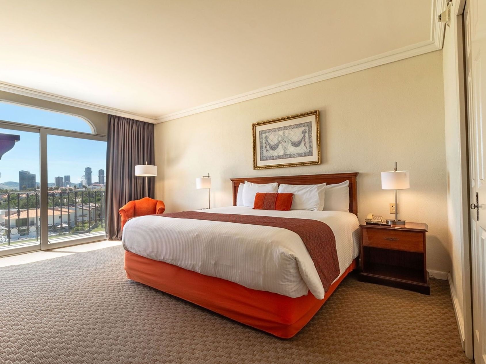 Luxury King Deluxe room featuring a private balcony with scenic city and skyline views at Camino Real Puebla Angelopolis