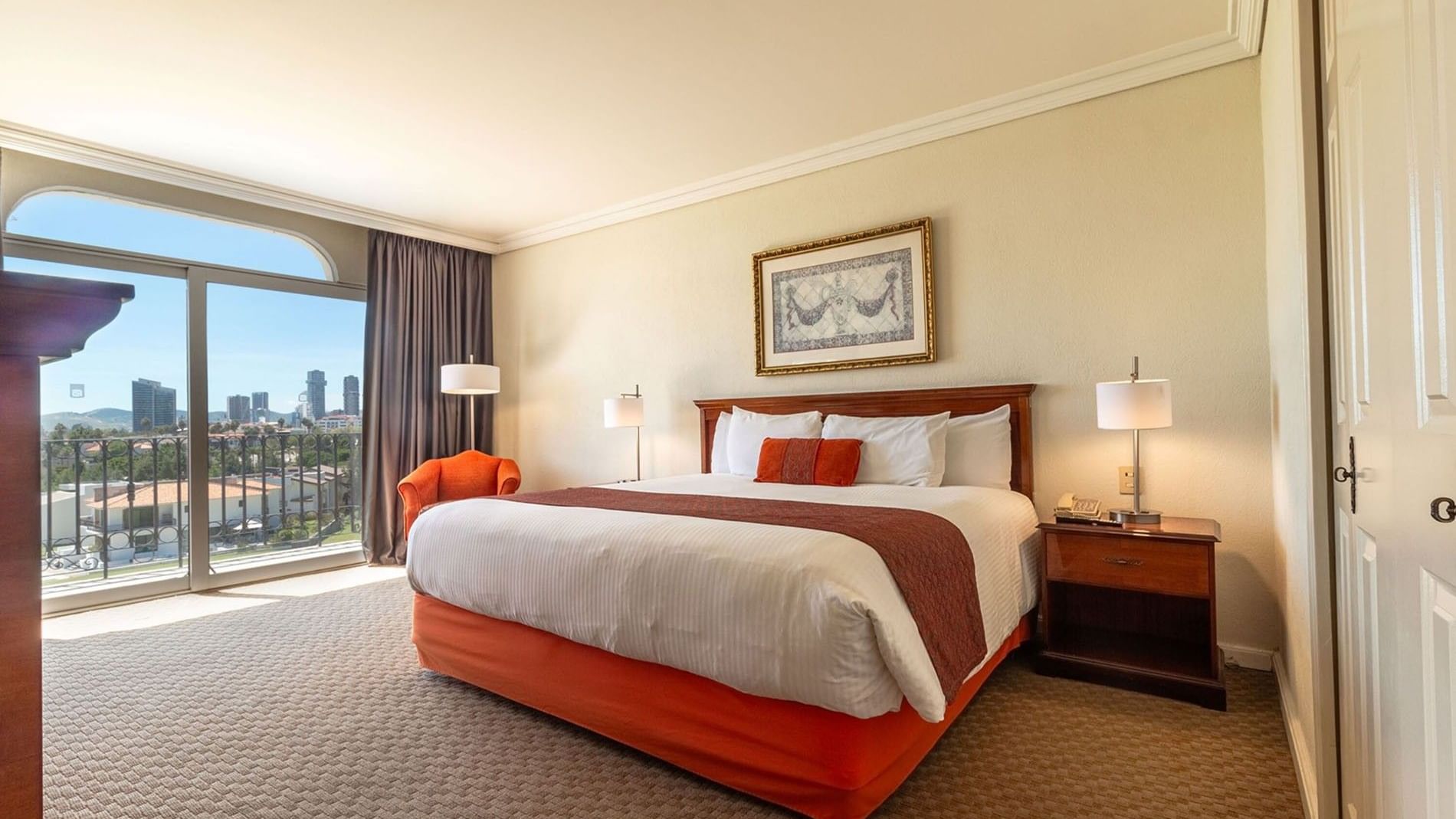Luxury King Deluxe room featuring a private balcony with scenic city and skyline views at Camino Real Puebla Angelopolis