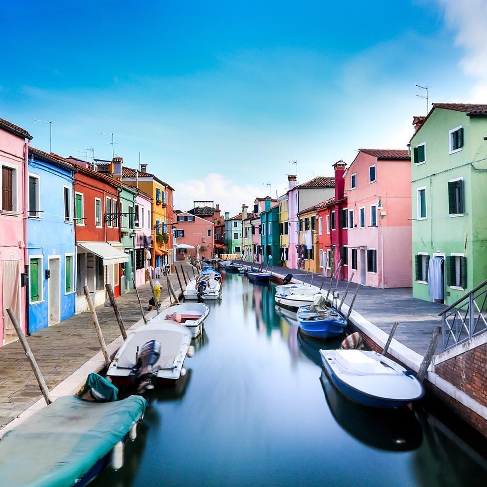 Boats in a canal in Burano City near Falkensteiner Hotels