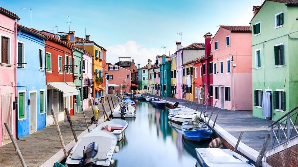 Boats in a canal in Burano City near Falkensteiner Hotels