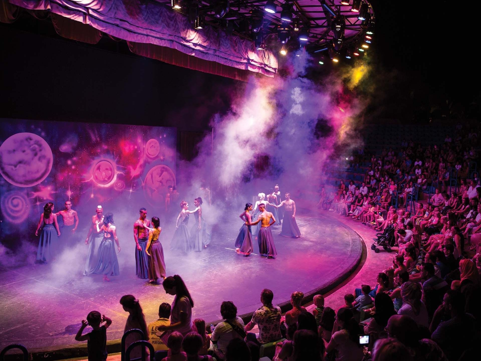 A group of individuals performing on stage at Titanic Deluxe Lara