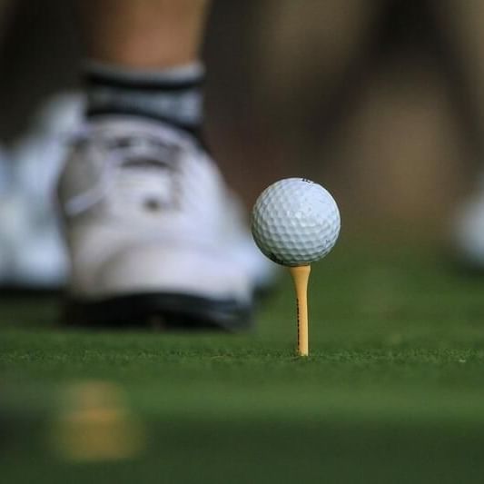 Close-up of a golf ball on a tee near Waikiki Resort Hotel by Sono