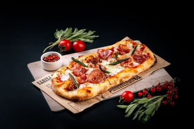 Close-up of pizza served at Carlton Hotel Bangkok Sukhumvit