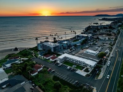 Aerial view of hotels and ocean at sunset