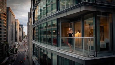A woman drinking wine in the balcony at ReStays Ottawa
