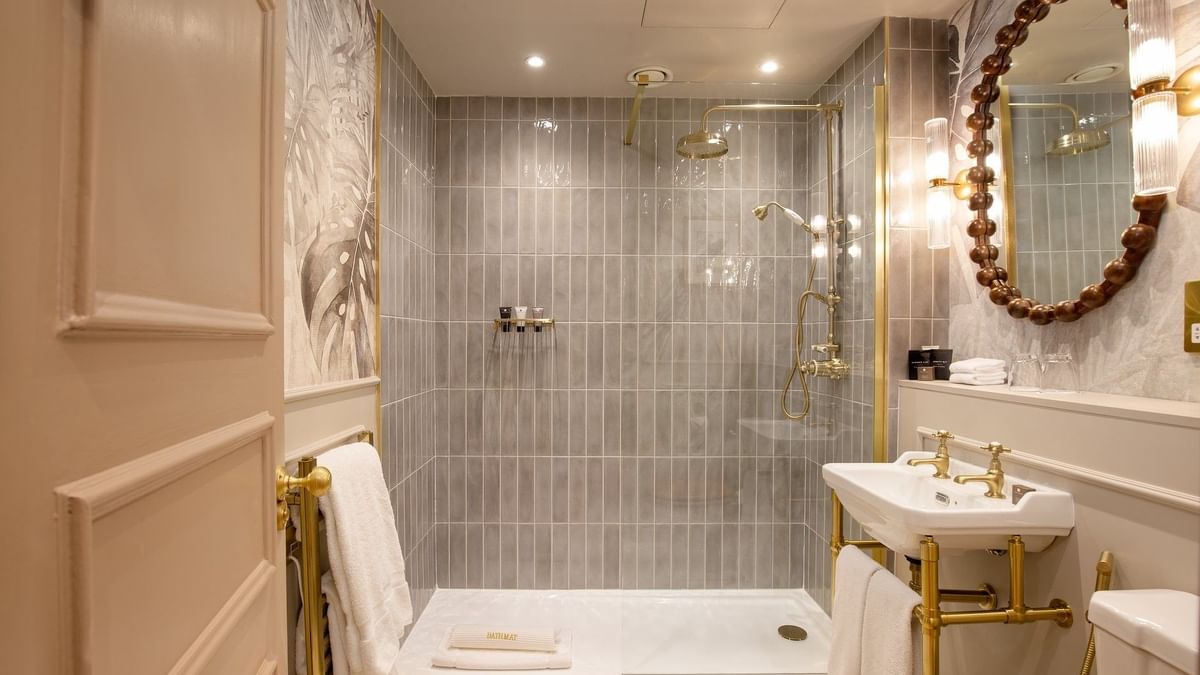 Studio Apartment bathroom featuring a marble vanity with bathtub at The Capital Hotel, Apartments and Townhouse