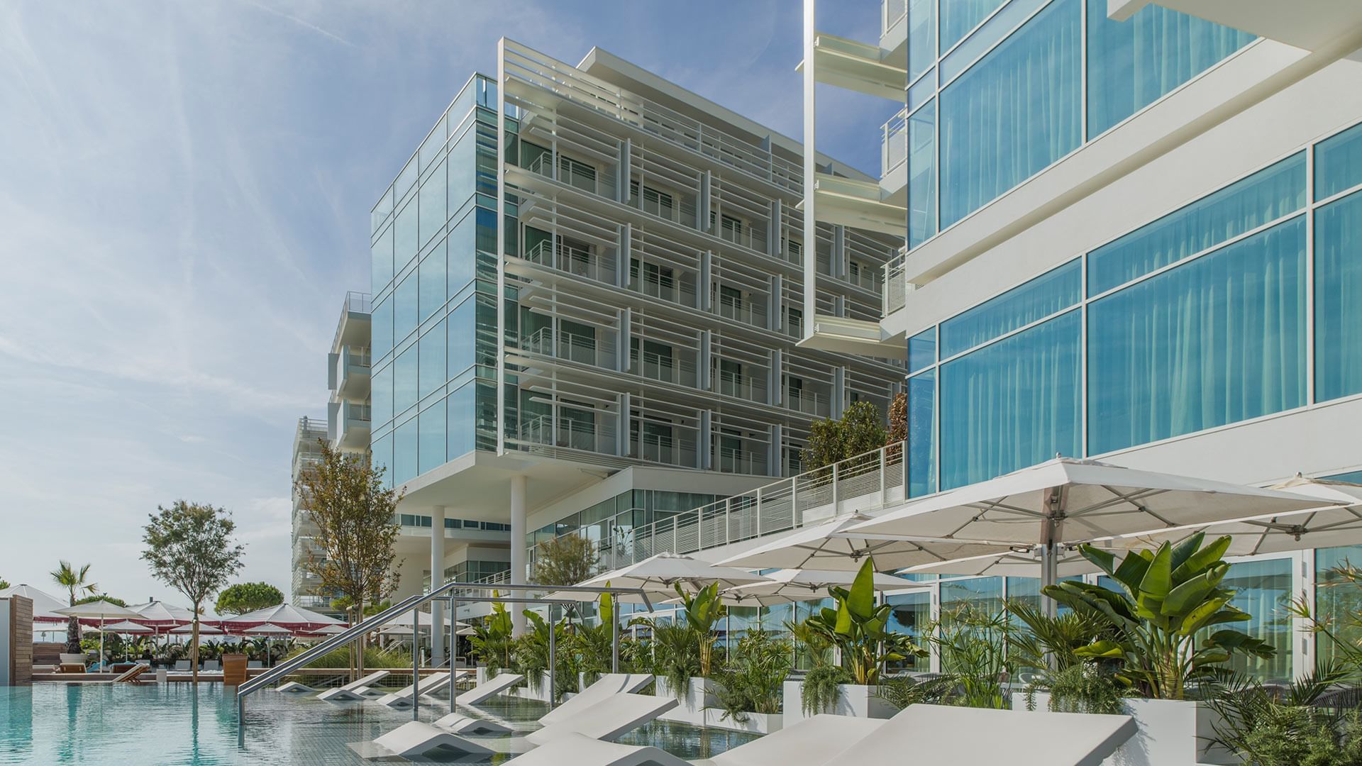 Pool with hotel exterior at Falkensteiner Residences Jesolo