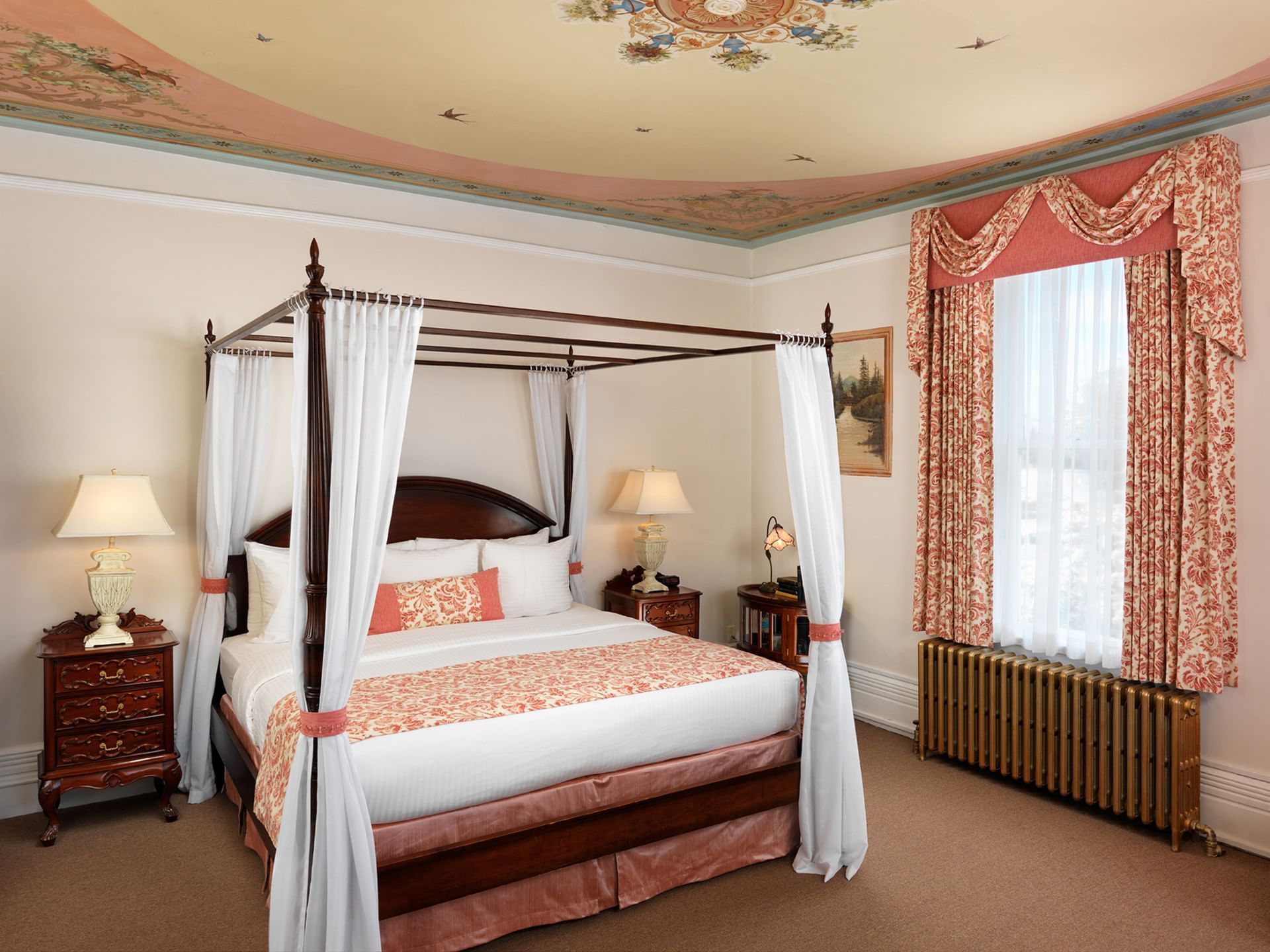 King-size bed by the window in Belleville Room at Pendray Inn & Tea House