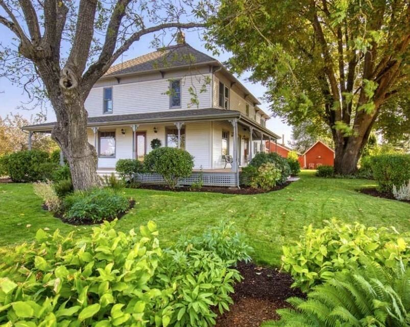 Beautiful two-story estate by lush green lawns under sheltering tree branches at Oregon Garden Resort