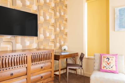 Interior of Queen Premiere Mellow with TV, work desk & comfy chairs at Retro Suites Hotel