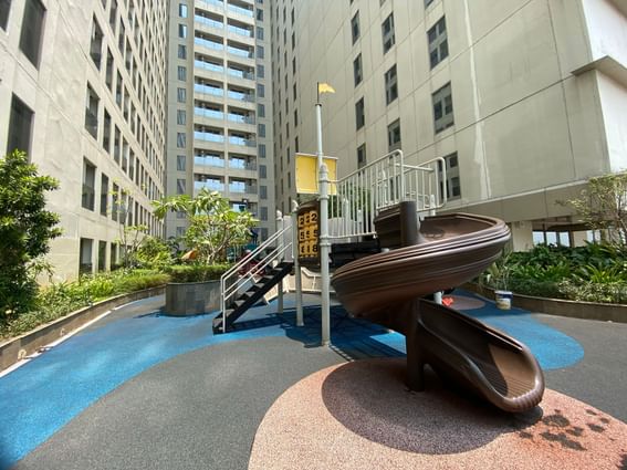 Playground in a courtyard with a building in the background at LK Pemuda Semarang Hotel & Residences