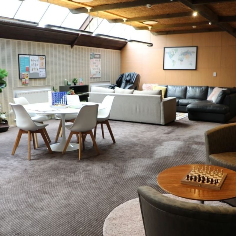 Comfortable living room with sofas, table, and chess board at La Trobe University - Chisholm College.