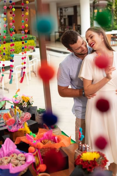 Couple embracing near a market stall with crafts and flowers at Villa Premiere Boutique Hotel & Romantic Getaway