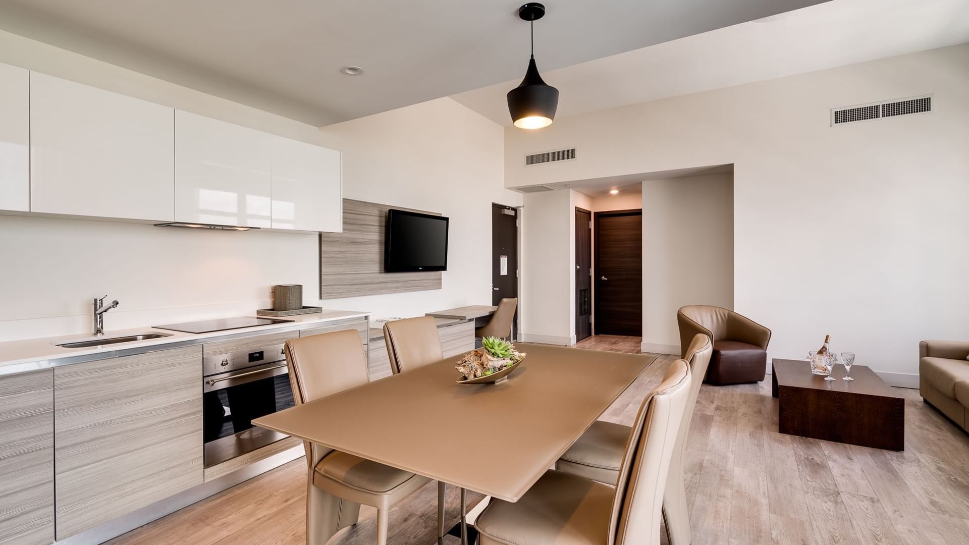 A modern open-plan living space with kitchen, dining area, and living room.