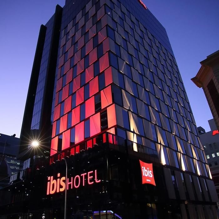 Exterior view of the Ibis Adelaide with prominent illuminated signage