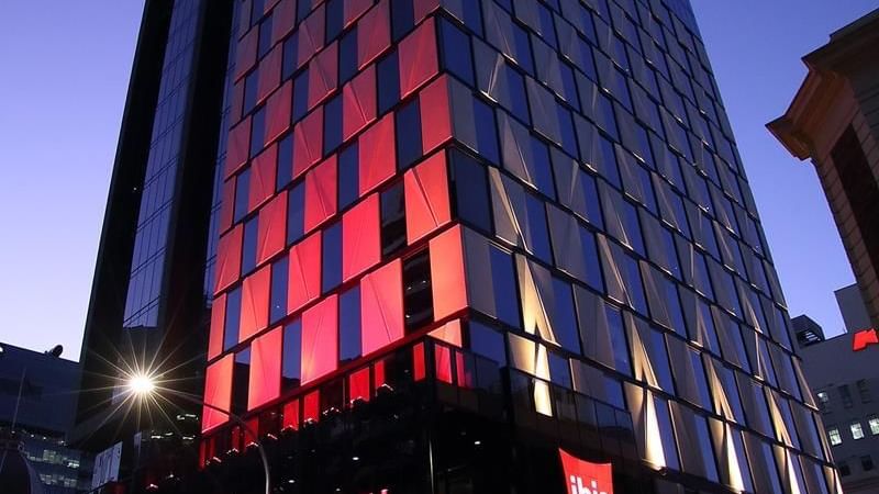 Exterior view of the Ibis Adelaide with prominent illuminated signage