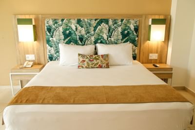 A king bed in Garden View Room at Playa Blanca Beach Resort