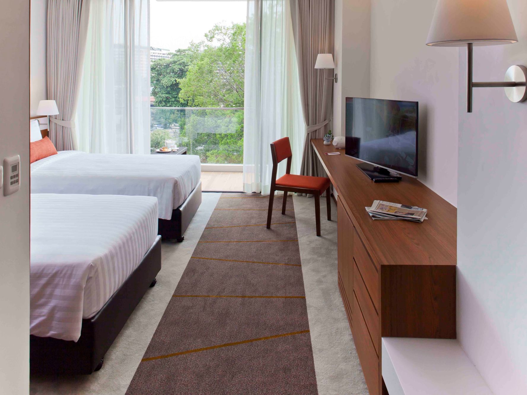 Beds, working desk with TV at Eastin Hotel & Residences