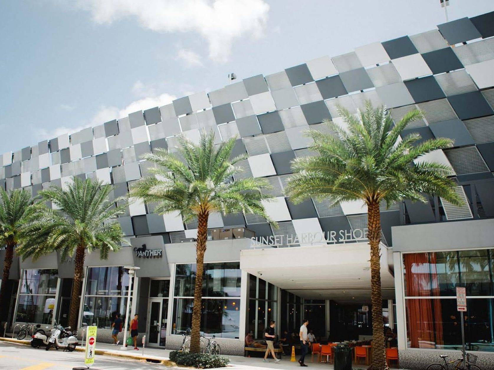 Sunset Harbour Shops near Riviera Hotel South Beach, with distinctive checkered architecture and tropical palms