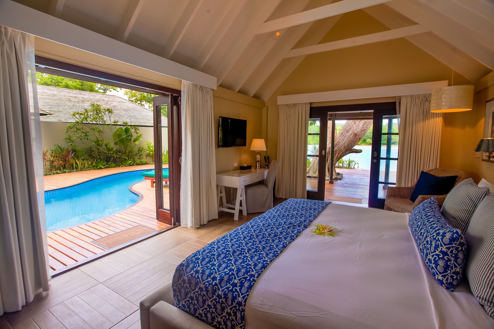 Efate Pool Villa featuring a blue patterned bed runner and a private outdoor dipping pool at warwick le lagon-vanuatu