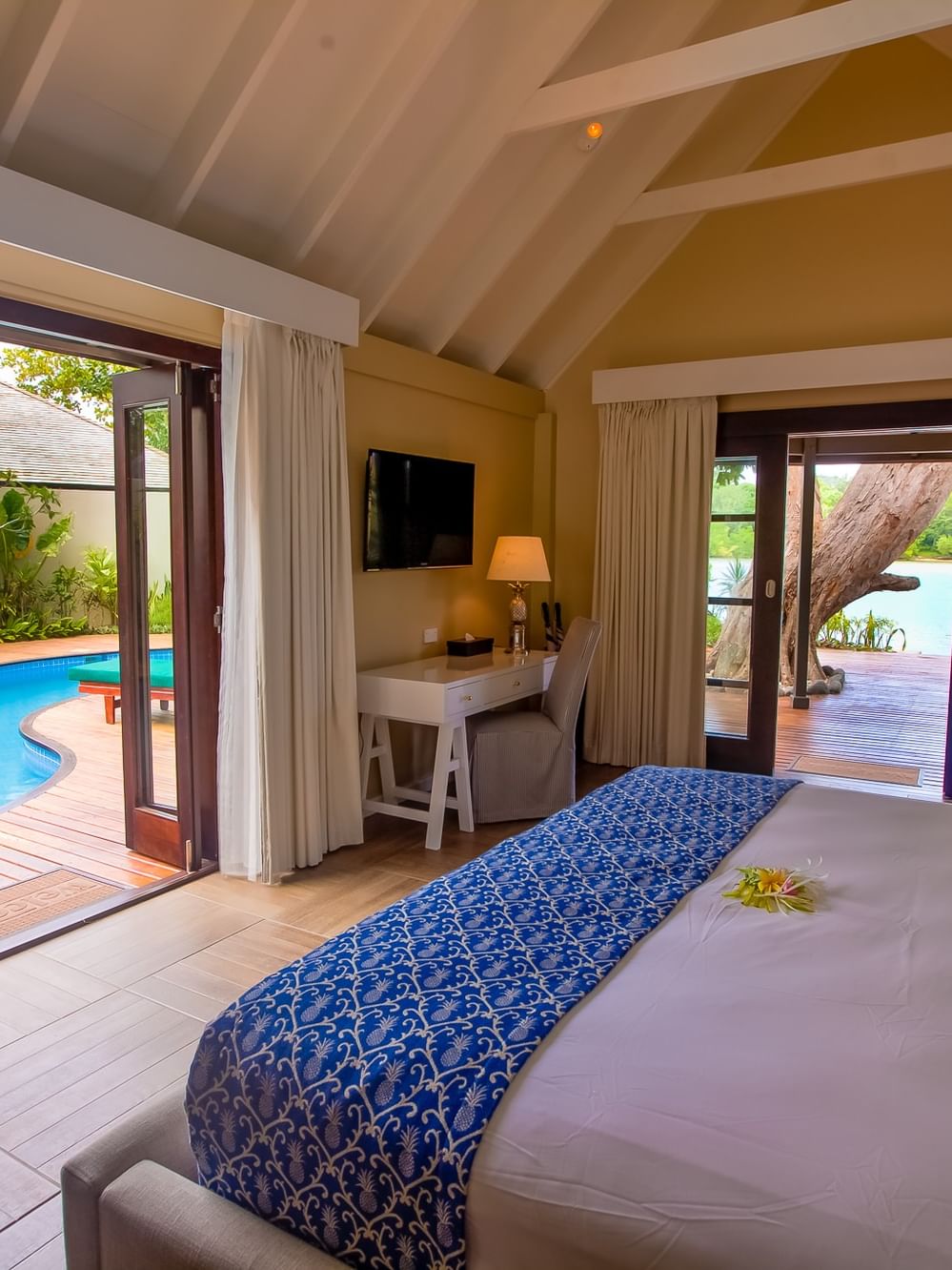 Efate Pool Villa featuring a blue patterned bed runner and a private outdoor dipping pool at warwick le lagon-vanuatu