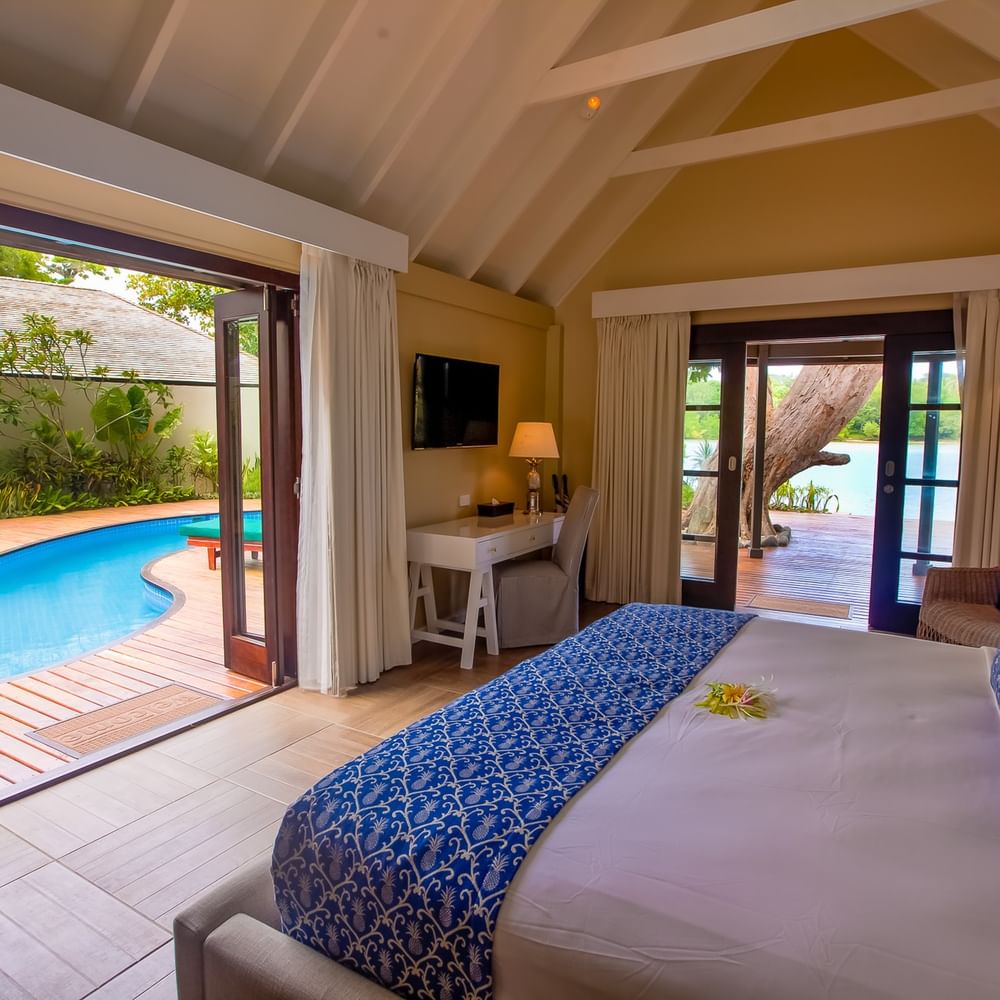 Efate Pool Villa featuring a blue patterned bed runner and a private outdoor dipping pool at warwick le lagon-vanuatu