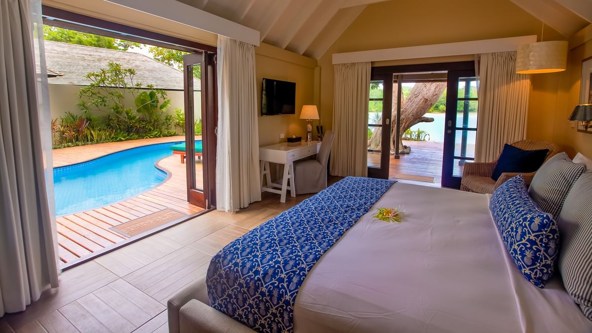 Efate Pool Villa featuring a blue patterned bed runner and a private outdoor dipping pool at warwick le lagon-vanuatu