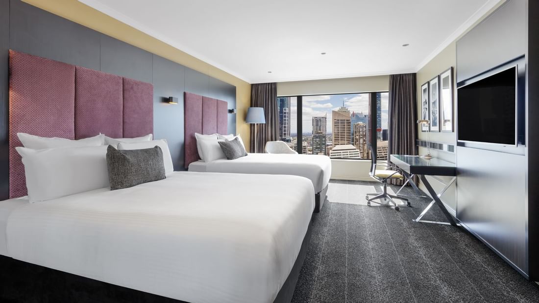 TV & work desk facing the beds in Deluxe Room with carpeted floors at Pullman Sydney Hyde Park