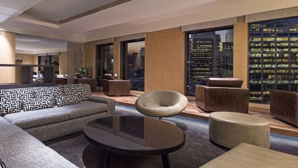 Interior of a lobby with lounges and city view at Fullerton Hotel Sydney