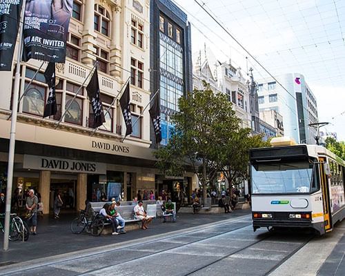 Tram passing by Melbourne Shopping center near Jasper Hotel