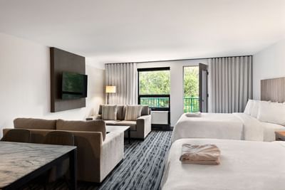 TV lounge area facing the beds in Standard Two Queen Beds With Balcony at Temple Gardens Hotel & Spa