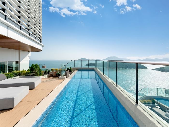 Outdoor pool area with sea view in The Penthouse Pool Suite at Fullerton Ocean Park Hotel Hong Kong