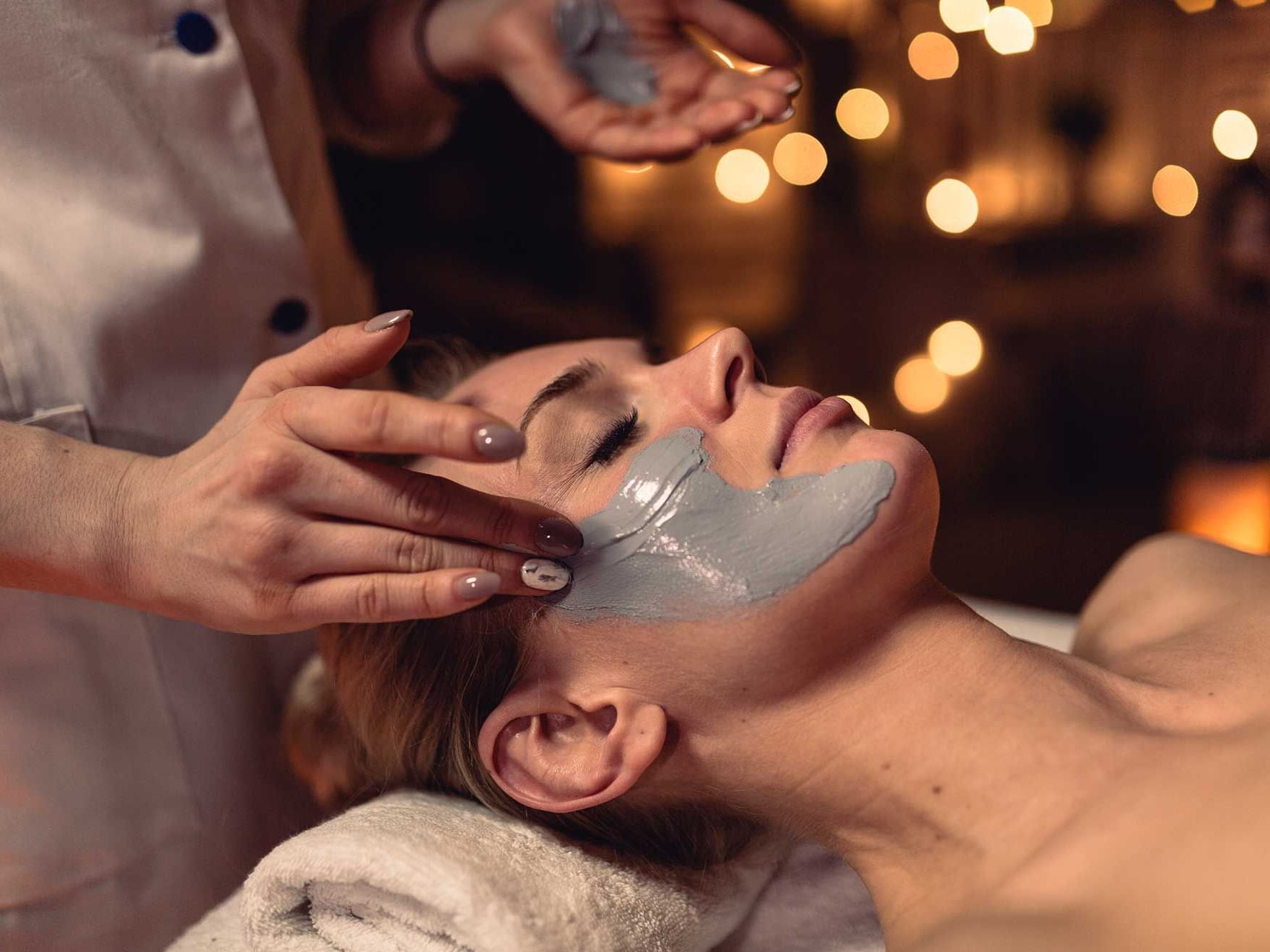 Lady applying a face mask 