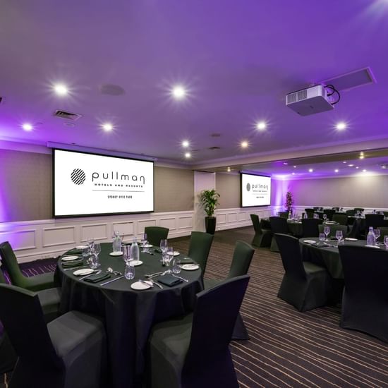 Banquet set-up with projector screens in Cook Room at Pullman Sydney Hyde Park