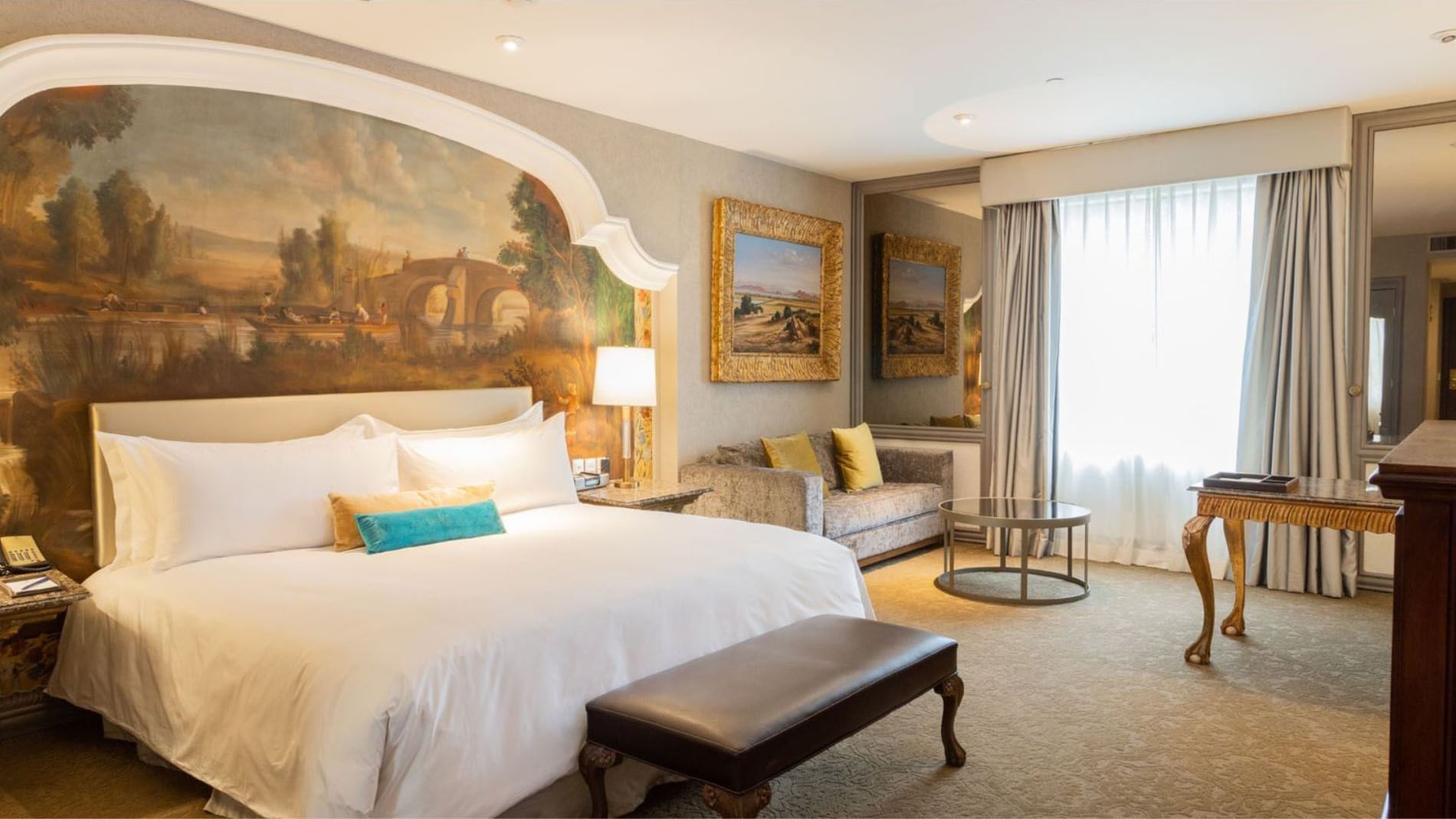 King Executive Tower with a scenic mural, velvet couch, and gold-framed mirrors at Quinta Real Monterrey