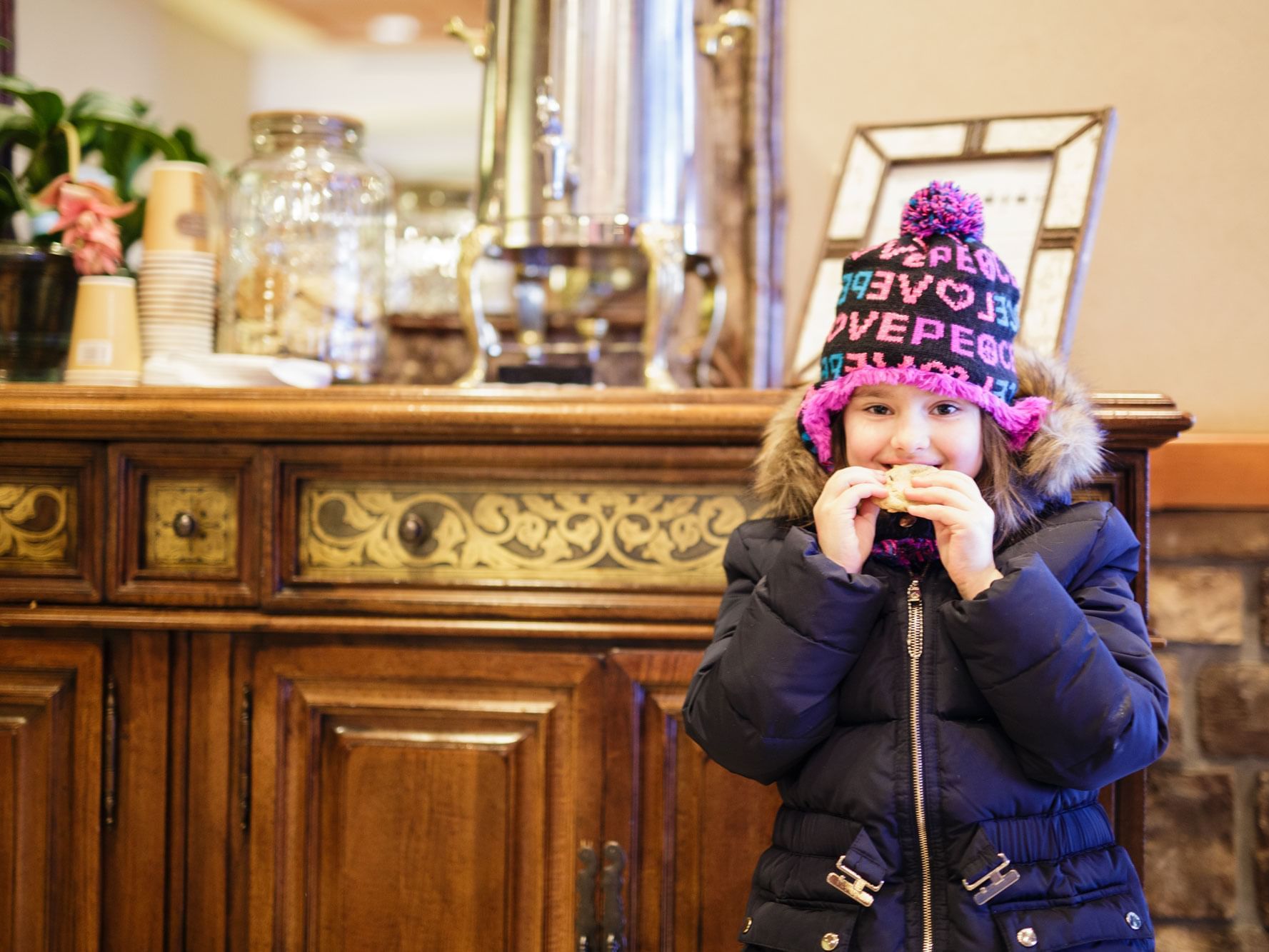 A girl eating cookies in The Lake House lobby.