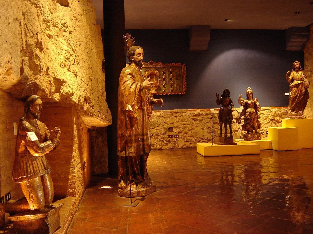 Interior of Casa Santo Domingo Museums featuring an array of human statues near Porta Hotel Antigua